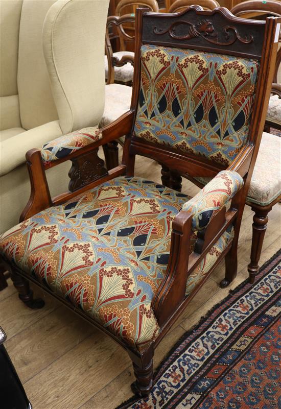 An upholstered walnut elbow chair